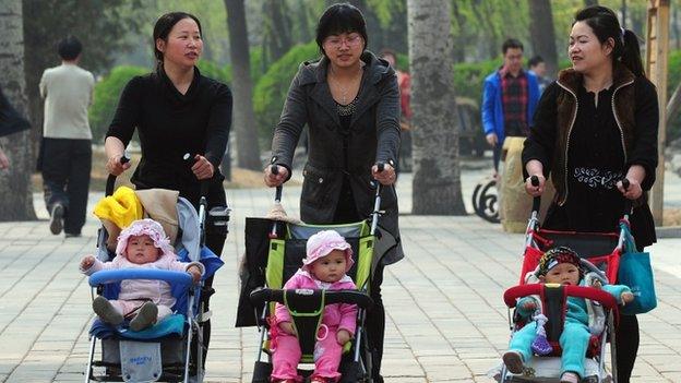 Chinese mums pushing babies in a pram.