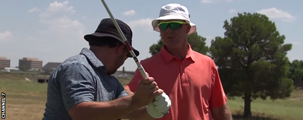 Steve Young (right) gives a golf lesson