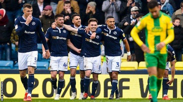 Millwall players celebrate after an own goal by Ahmed Hegazi