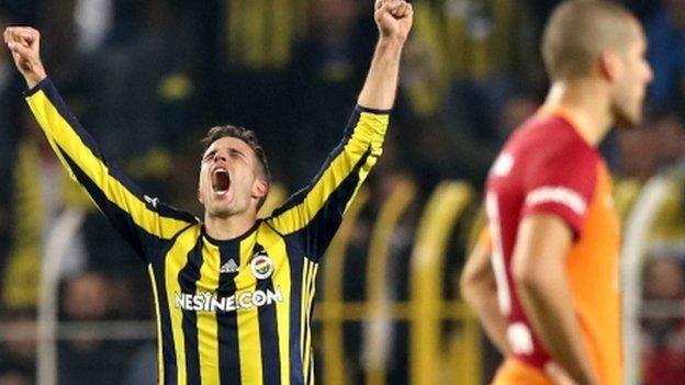 Robin van Persie celebrates scoring for Fenerbahce against Galatasaray.