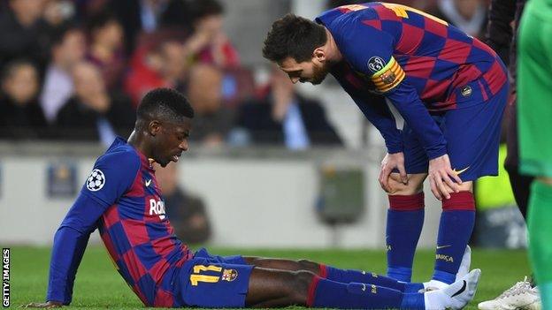 Barcelona winger Ousmane Dembele (left) is consoled by Lionel Messi (right) after injuring his thigh against Borussia Dortmund