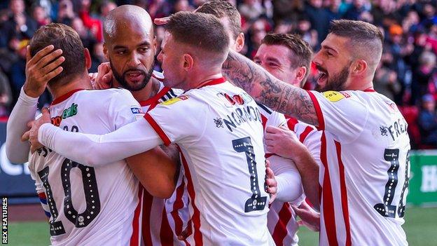 David McGoldrick (second from left) celebrates the goal that sent Sheffield United top of the Championship