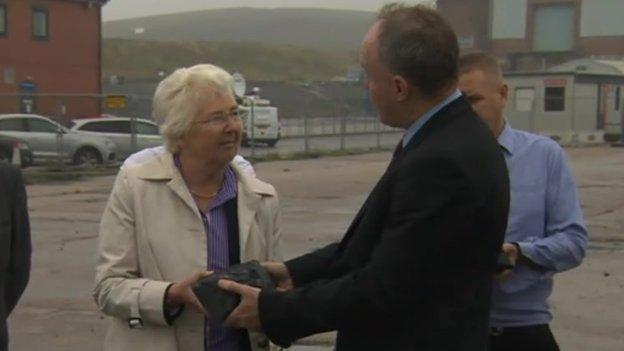 Ros Jones accepts lump of coal from John Grogan