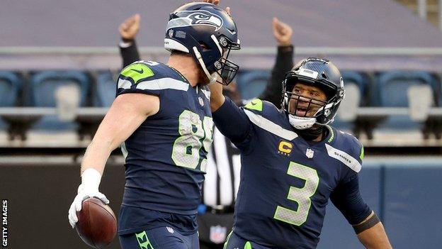 Will Dissly of the Seattle Seahawks celebrates with Russell Wilson after scoring a 10 yard touchdown against the New York Jets