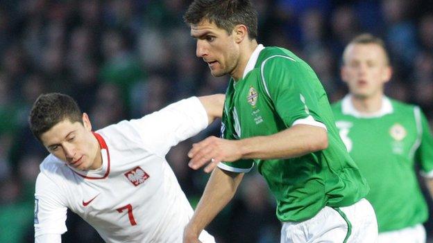 Poland's Robert Lewandowski battles with Northern Ireland's Aaron Hughes during the World Cup qualifier at Windsor Park in March 2009