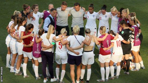 Phil Neville speaks to his players after their defeat by Sweden in the third-place play-off