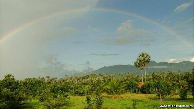 Rainbow over green countryside