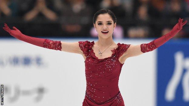 Evgenia Medvedeva poses at the end of a figure skating routine