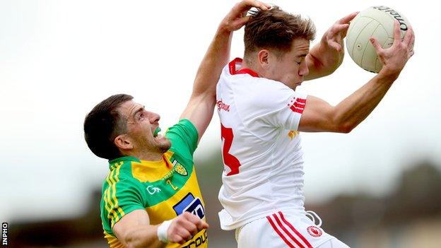 Donegal's Paddy McGrath challenges for a high ball with Tyrone's Mark Bradley