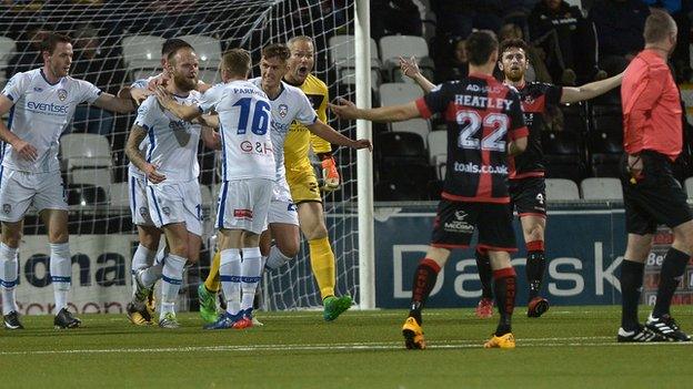 Gareth McConaghie celebrates scoring as Crues players claim for handball against the Bannsiders defender