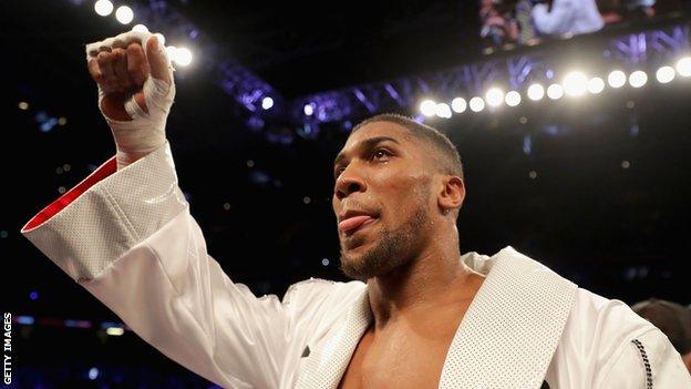 Anthony Joshua celebrates his win