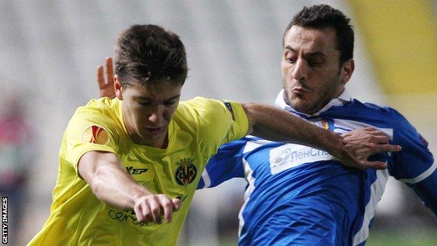 Villarreal's Luciano Vietto and Apollon's Georgios Vasiliou fight for the ball