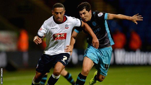 Liam Feeney of Bolton is tackled by Fernando Forestieri of Sheffield Wednesday