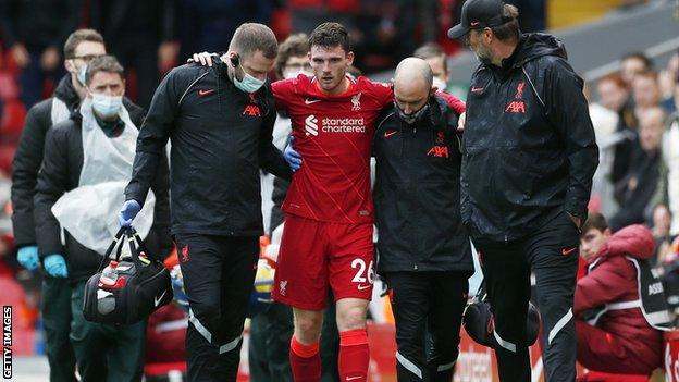 Andy Robertson helped off the pitch in pain