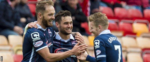 Ross County players celebrate Martin Woods' (left) final goal