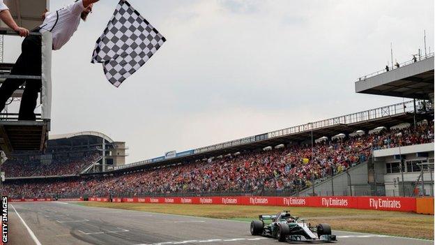 Lewis Hamilton crosses the line to win the 2018 German Grand Prix