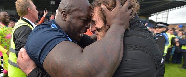 Ainsworth (right) celebrates promotion with Adebayo Akinfenwa