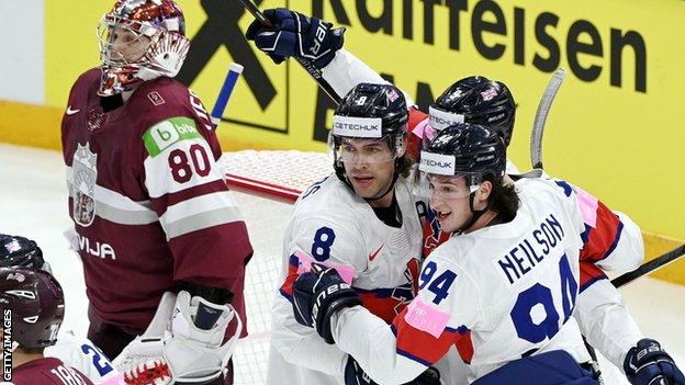 Great Britain celebrate a goal against Latvia at the Ice Hockey World Championship