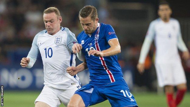 Wayne Rooney battles for possession with Gylfi Sigurdsson at Euro 2016