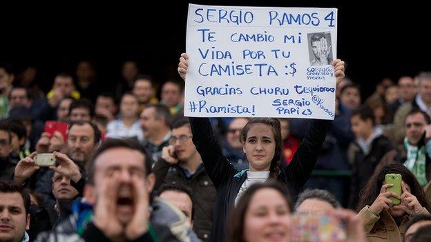 Real Madrid fan holds sign asking for Ramos shirt