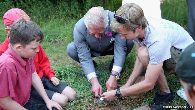 Prince Charles taking part in bush-skills class