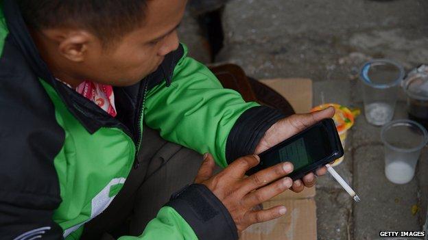 A Go-Jek rider checking for bookings