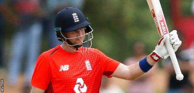 Joe Root raises his bat after reaching 50