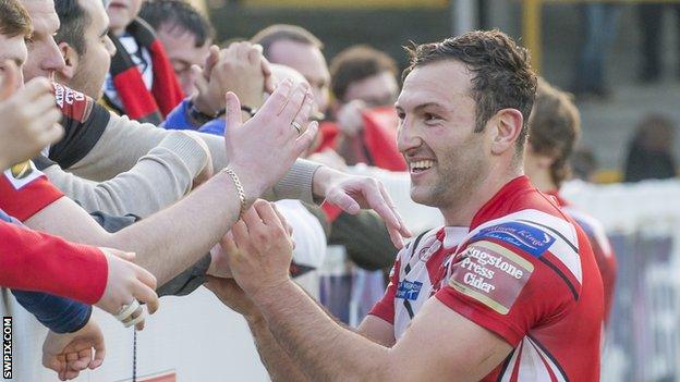 Tommy Lee celebrates with the Salford fans