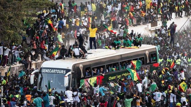 Aliou Cisse and Senegal show off the Africa Cup of Nations trophy on their return to the West African country