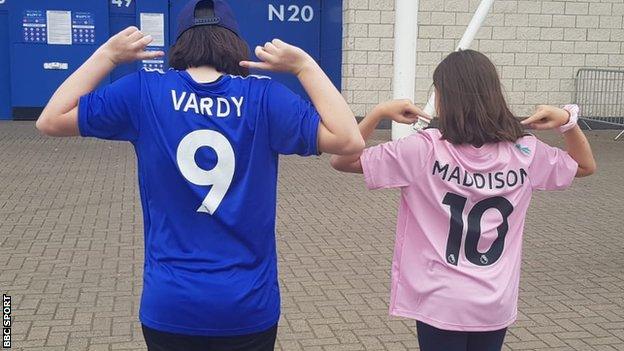 Two Leicester supporters show off the names on the back of their shirts