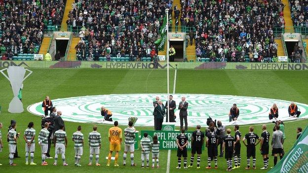 Celtic unfurl the Scottish Premiership flag at the start of season 2014-15