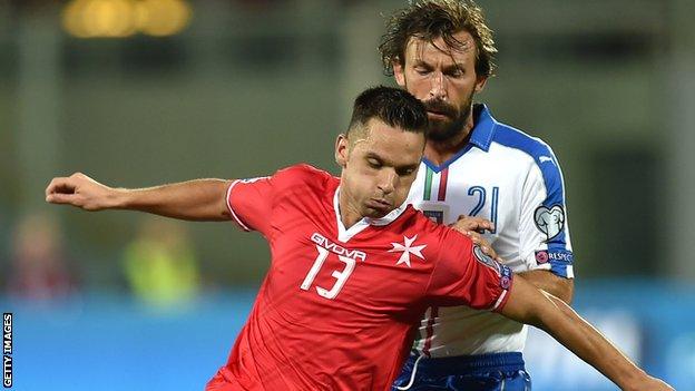 Malta's Andre Schembri in action against Italy's Andrea Pirlo