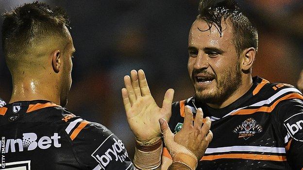 Josh Reynolds celebrates a try with Luke Brooks