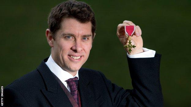 Paul Hawkins poses with his OBE