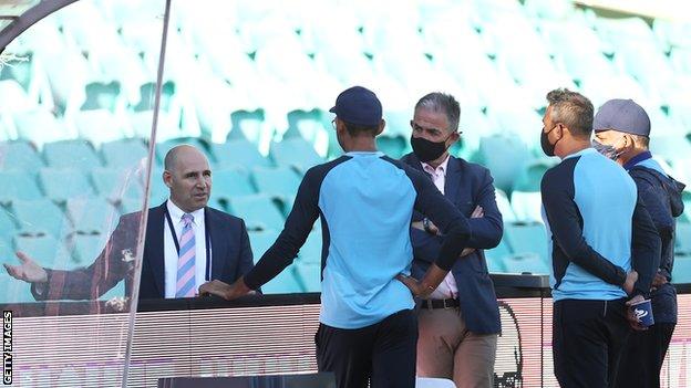 India staff speak to Cricket Australia chief executive Nick Hockley (far left) after the close of play on day three of the third Test