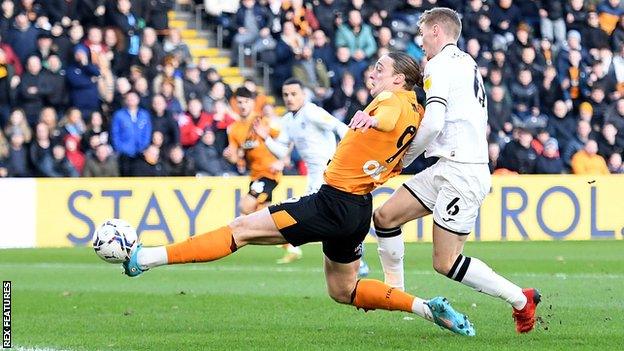 Tom Eaves stretches to touch in his third goal of the season