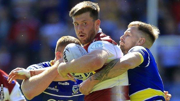 Joe Greenwood (centre) in action for Wigan