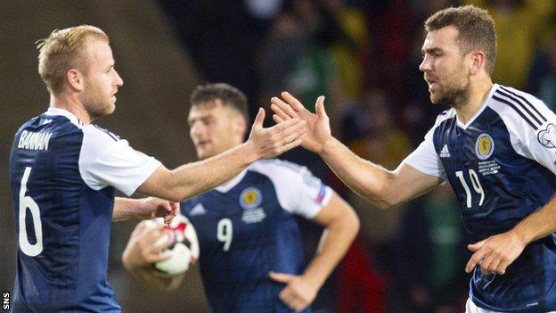 Scotland's Barry Bannan congratulates scorer James McArthur