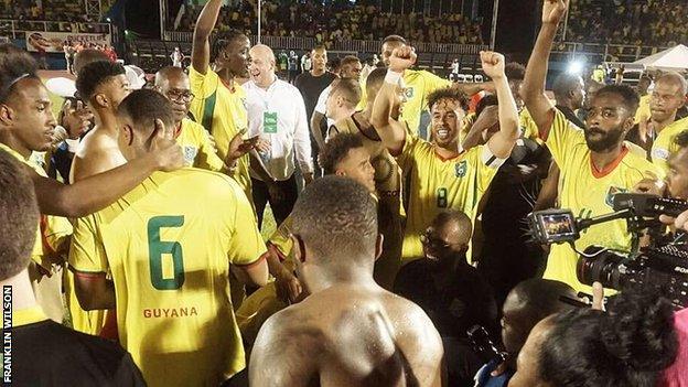 Guyana players celebrate after beating Belize to qualify for the Gold Cup