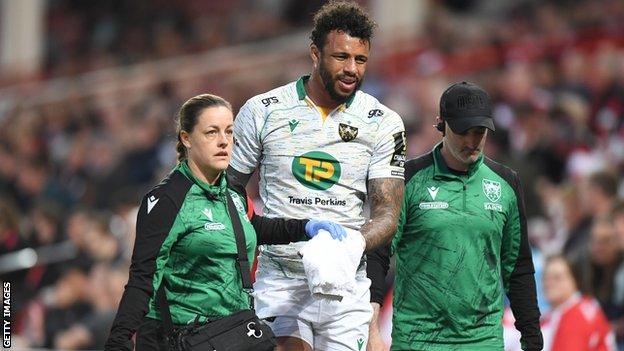 Courtney Lawes leaves the field with a hand injury while playing for Northampton