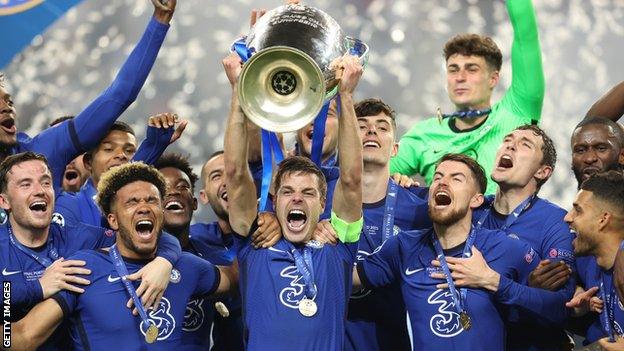 Chelsea players celebrate with the Champions League trophy after victory over Manchester City in the 2021 final