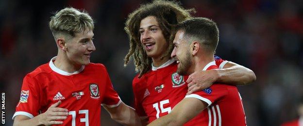 David Brooks and Ethan Ampadu congratulate Aaron Ramsey who scored Wales' third goal