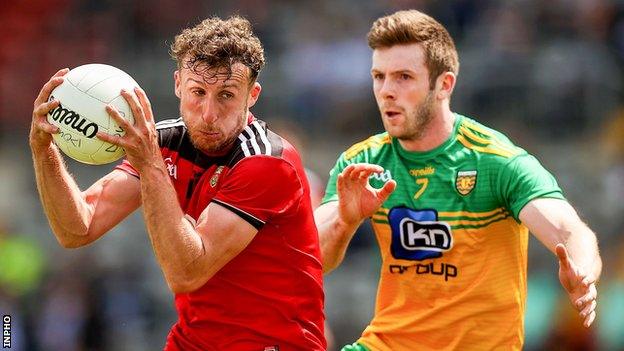 Barry O'Hagan wins possession ahead of Donegal's Eoghan Ban Gallagher