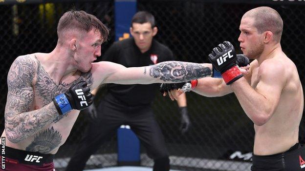 Rhys McKee throws a punch in his UFC contest against Alex Morono