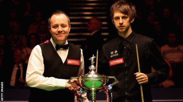 John Higgins and Judd Trump (right)