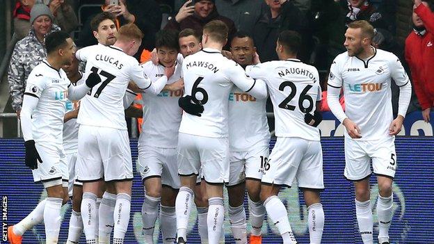 Swansea celebrate taking the lead against West Ham