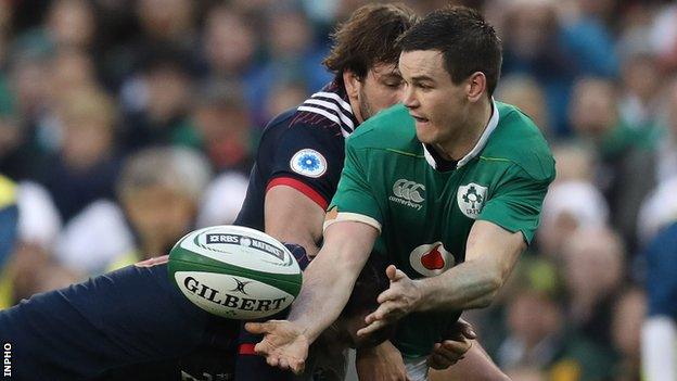 Johnny Sexton manages to get the ball away despite being tackled in the win over France