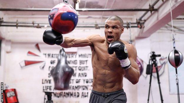 British boxer Chris Eubank Jr punches a punching bag during a open workout session