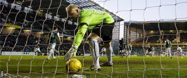 Conrad Logan picks the ball out of the Hibs net