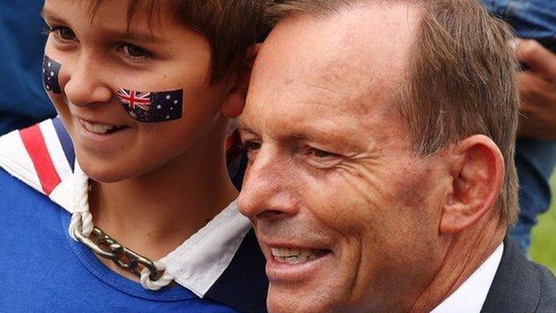 Australian Prime Minister Tony Abbott with a young boy on Australia Day